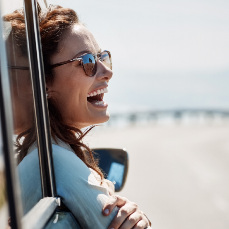 Woman happy in a car